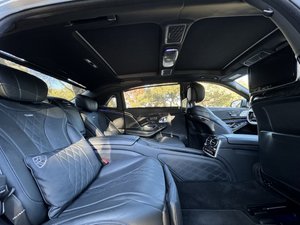 Professional chauffeur opening luxury wedding limo door for bride